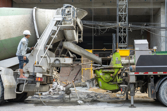 Mixer truck pouring concrete in mold from