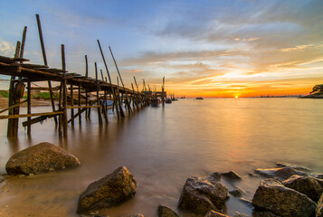 Burning the sky on the wooden pier in the fishing village of batam island