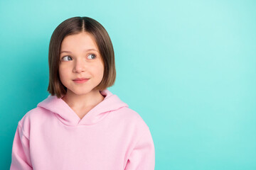 Fototapeta premium Photo of pretty short hairdo small girl look empty space wear pink sportswear isolated on teal color background