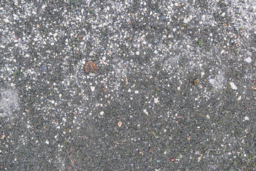 Texture of black old asphalt and pebbles