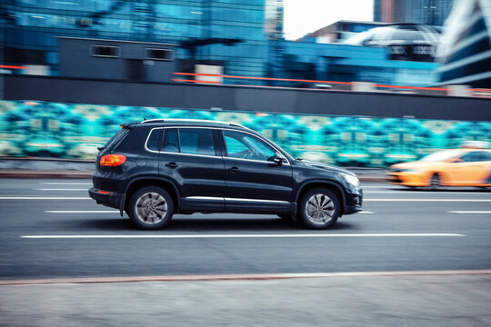 Black color Volkswagen Tiguan in fast motion on the street