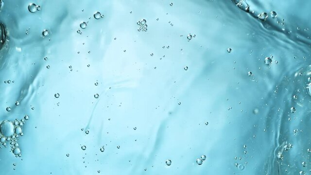 Super slow motion of water splash on light blue background. Filmed on high speed cinema camera, 1000 fps.