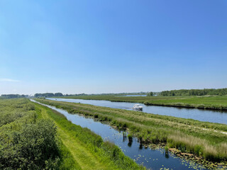 Fototapeta na wymiar A boat on a canal at De Alde Feanen National Park