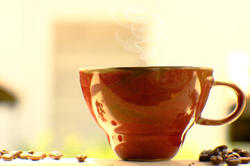 Coffee cup and coffee beans on table, americano coffee in coffee shop, copy space for text, close up white cup on counter