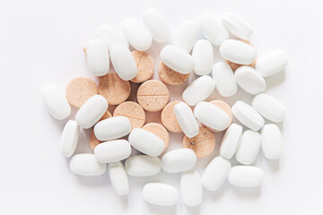 Fototapeta na wymiar White pills on a White background. Healthcare and medicine.
