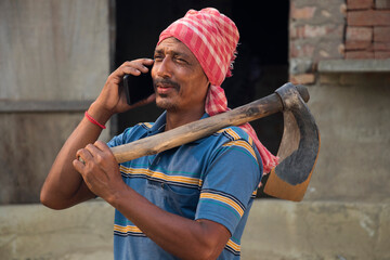 Indian farmer talking on smart phone 