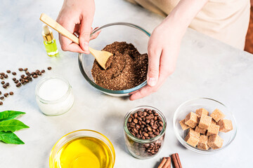 Woman mixing ingredients preparing coffee scrub or mask for skin treatment