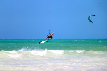 Kitesurfer jumping in the air above the ocean in Zanzibar, beautiful exotic background