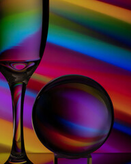 Wine Glass and Lens Ball with abstract background.