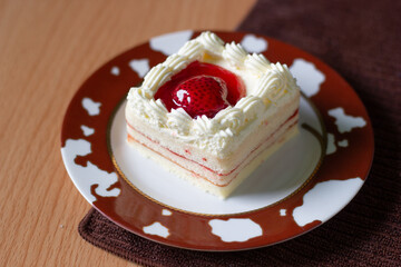 Strawberry cake decorate with Strawberry sauce and cream.