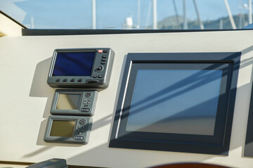 Close-up view to a dashboard with navigation system of modern luxury yacht  in the captain's cockpit
