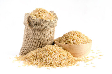 Dry brown rice seed pile in sack and wooden bowl on white background, for carbohydrate food raw material or agricultural product concept