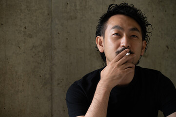タバコを吸う日本人の中年男性1 コピースペースあり
