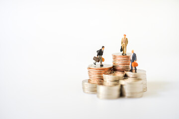 Miniature people Group of Businessman figure standing on stack of coin. Business Money and Banking deposit or withdraw money business financial Technology Money transfer concepts