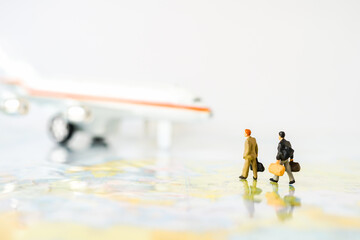 Miniature business people : businesses team walking to airplane on world map with copy space for travel around the world, business trip traveler adviser agency or online world wide marketing concept.