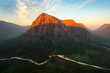 Iconic mountain peak Buachaille Etive Mor covered in beautiful golden light on a fresh Summer...