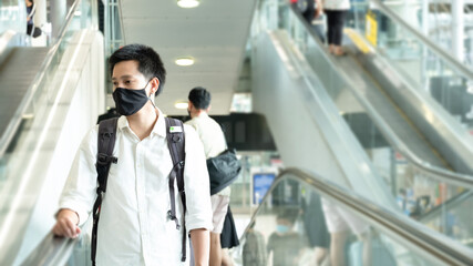 man asian smile with the backpack at the airport. Young handsome man waiting for boarding, walks...
