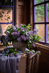 Bouquet of lilacs in a vintage basket. Beautiful violet Lilac flower still life Easter border design on wooden table.