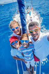 Family with adorable kids resting on yacht