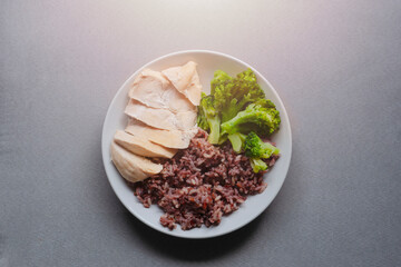 Top view of chicken boiled with vegetables served on white plate on  gray cloth background