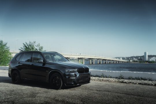 Engels, Russia - May 26, 2021: BMW X5 car is parked at embankment near Volga river in Engels city