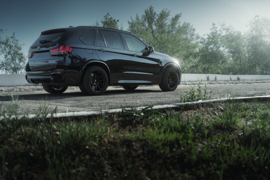 Engels, Russia - May 26, 2021: BMW X5 car is parked at embankment near Volga river in Engels city