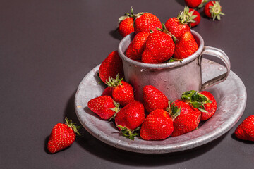 Concept of summer food with a strawberry on a black stone background