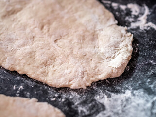 Close and selective focus on a home made Indian chapati flat bread on a baking sheet ready for cooking