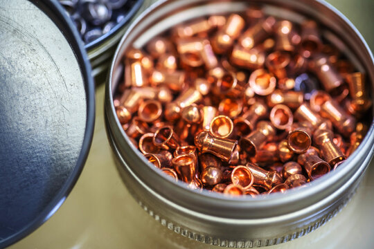 Copper bullets for pneumatic weapons. Shooting sport ammunition in a metal box. Close-up