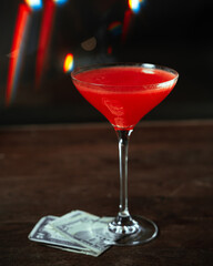Elegant luxury passionate red cocktail with dollars