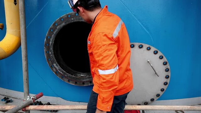 Male worker outside before checking manhole into fuel tank oil area confined space safety.