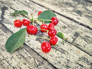 Fresh ripe red cherries on wood background.