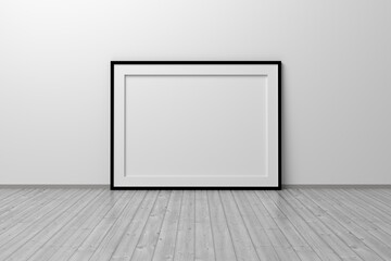 Mockup template of horizontal A4 frame with thin black frame border standing next to wall on wooden floor