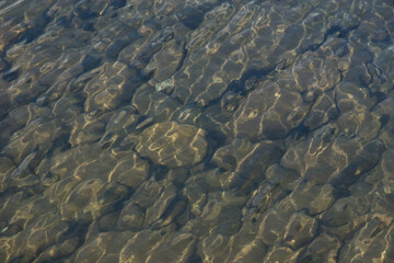 Background of large rocks under shallow water