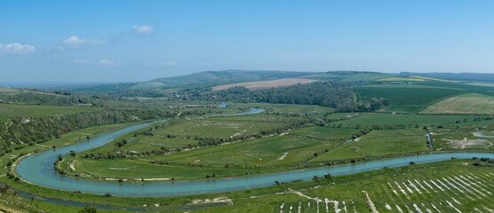 Fototapeta na wymiar Panoramic view of the meandering Cuckmere river and valley from the High and Over footpath towards Alfriston. West Dean, Seaford, East Sussex, England
