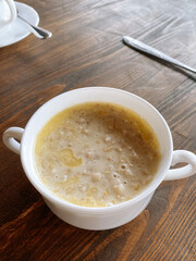 white plate with oatmeal on the wooden background