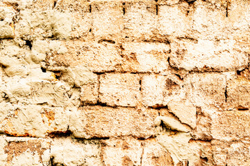 Texture of a brick wall with cracks and scratches which can be used as a background