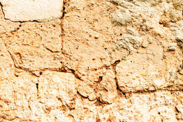 Texture of a brick wall with cracks and scratches which can be used as a background