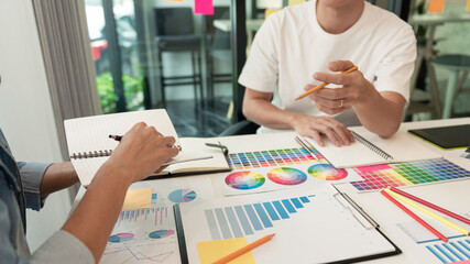 two designers discussing on the color tone for the excellent visual work