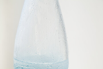 Closeup of plastic bottle with condensation water droplets