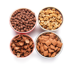 Bowls of different cereals on white background