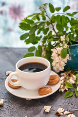 Cup of coffeel and acacia closeup. Nutrition. background with a cup of Coffee and acacia flowers.