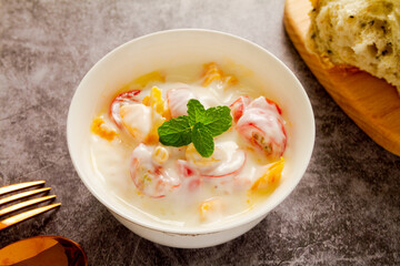 Mango and cherry tomato yogurt close up.