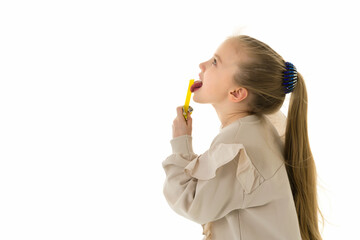 Cute little girl licks a candy.