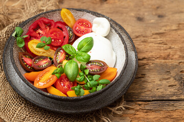Fototapeta na wymiar Salad with tomatoes and burrata cheese