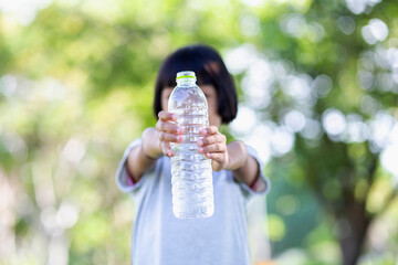 Lovely little girl drinking water