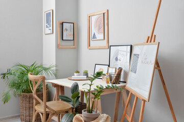 Interior of stylish room with modern workplace and pictures