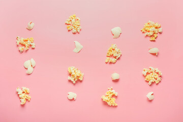 Tasty popcorn and butter on color background