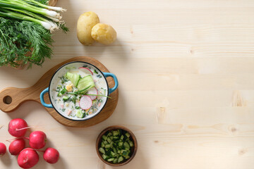 Traditional homemade freshness cold soup Okroshka with kefir , fresh chopped vegetables and on...