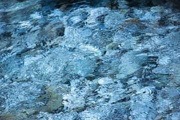 Magic blue caustics on the sea surface